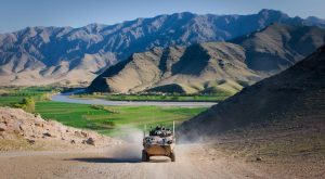 An Australian service light armored vehicle drives through Tangi Valley, Afghanistan