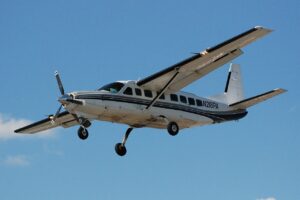 Small single propeller passenger Cessna 208 Caravan plane landing.