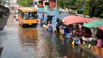 Bus crossing a street during flooding in Minburi, Bangkok.