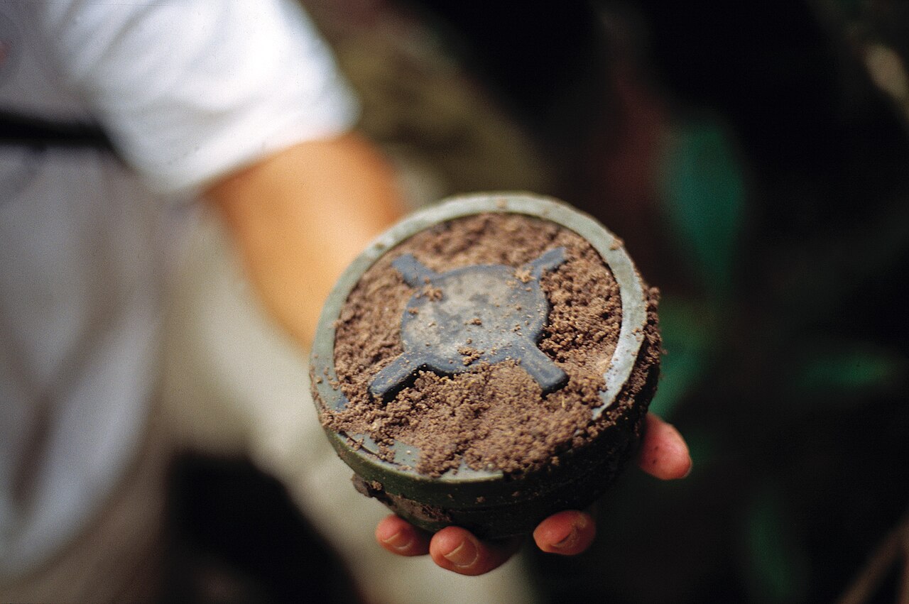Cambodian soldier holding a landmine.