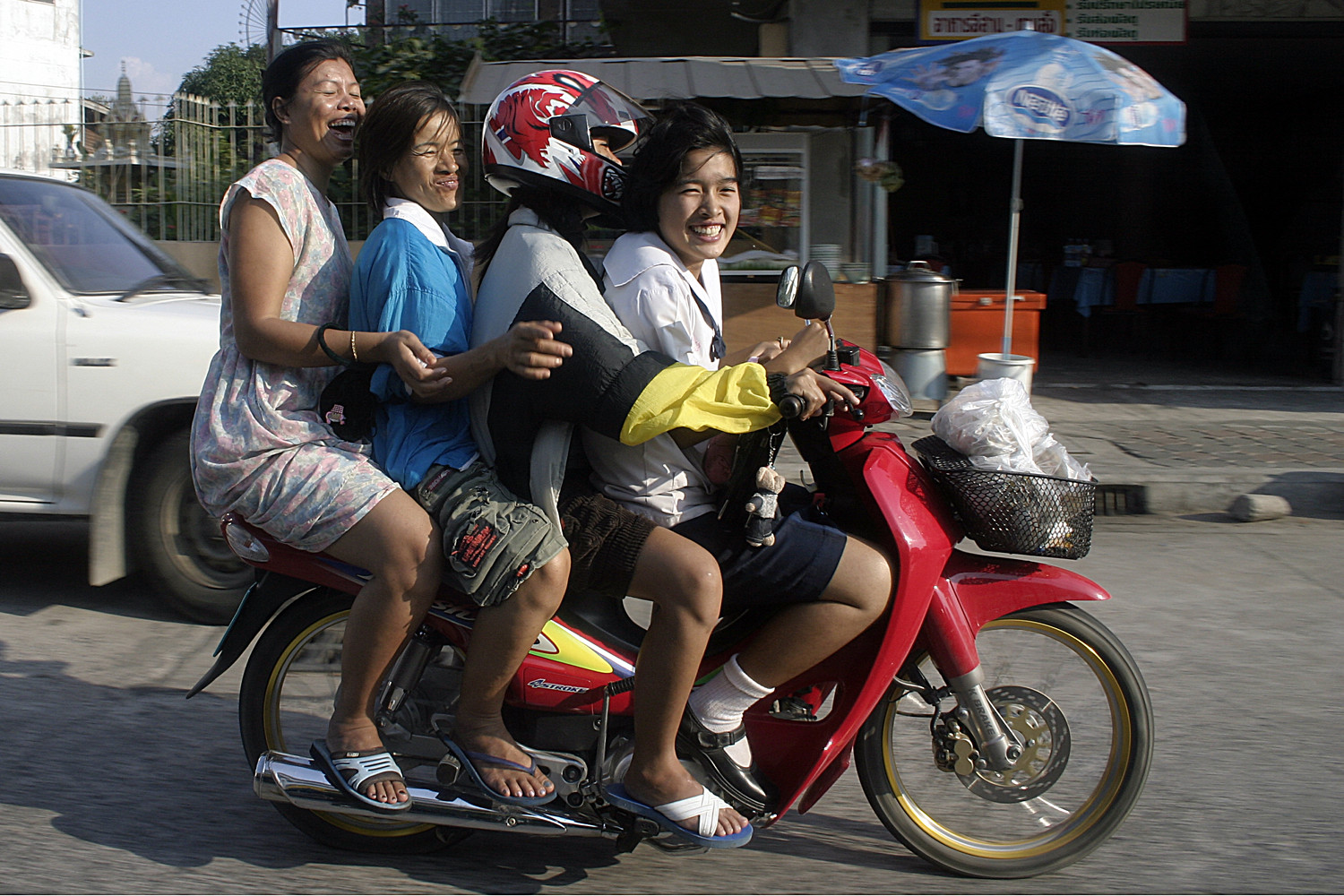 Four women riding a motorcycle in Pattaya.