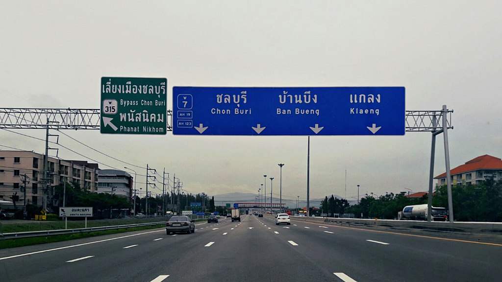 Road sign in Pattaya with directions: Bangkok - Chonburi, Phan Thong Intersection, heading to Chonburi.