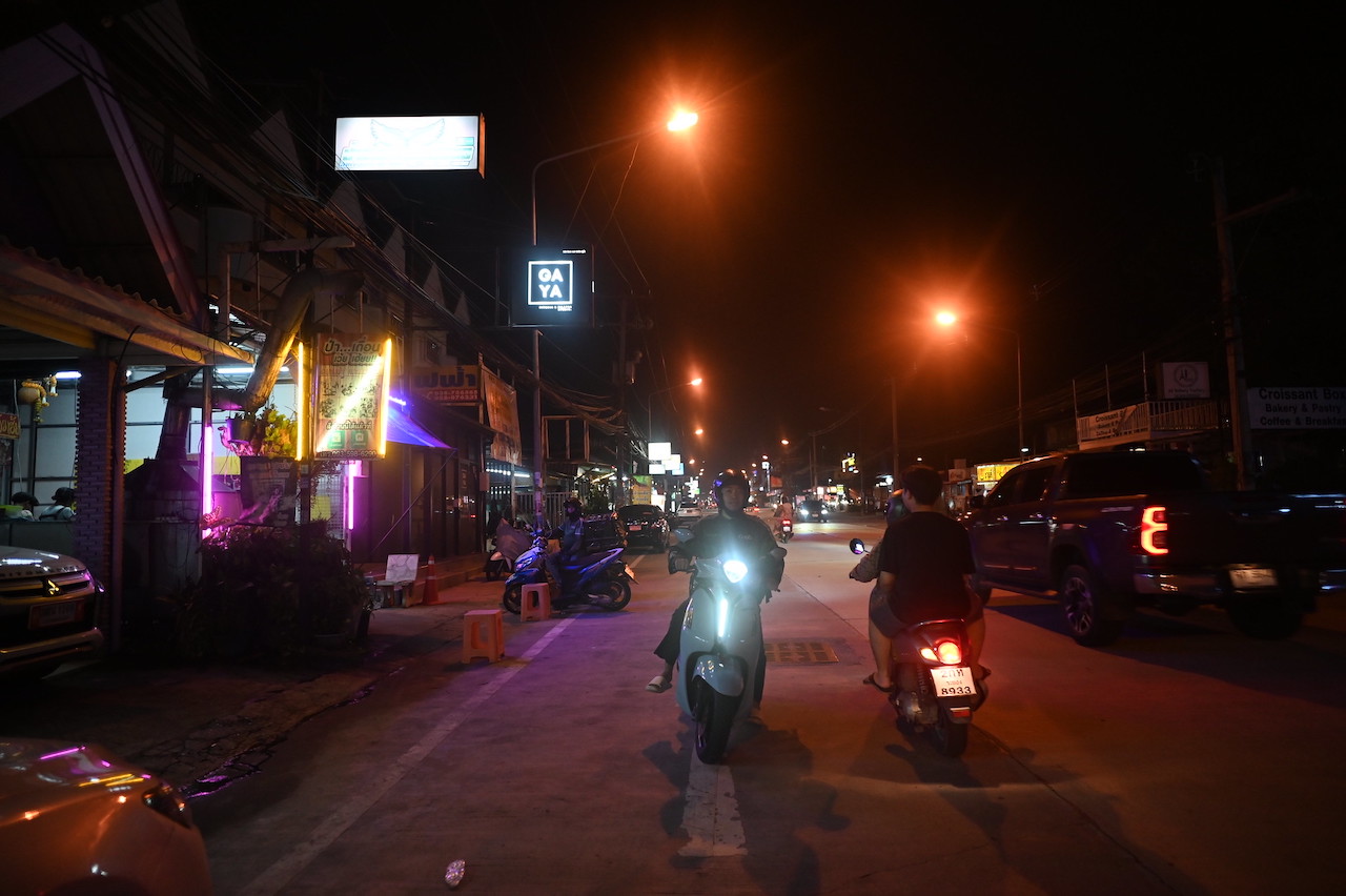 Men riding motorcycles at night on a street in Pattaya.