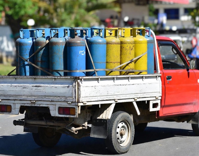 Pickup truck carrying LPG gas cylinders in Thailand.