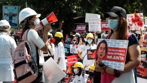 Demonstrators display banners during 2021 protests in Myanmar against Military Coup