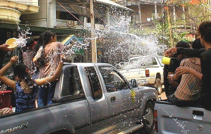 Water fight on top of pickup trucks during the Songkran Festival