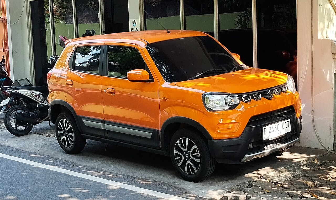 An orange Suzuki S-Presso parked in Jakarta, Indonesia.