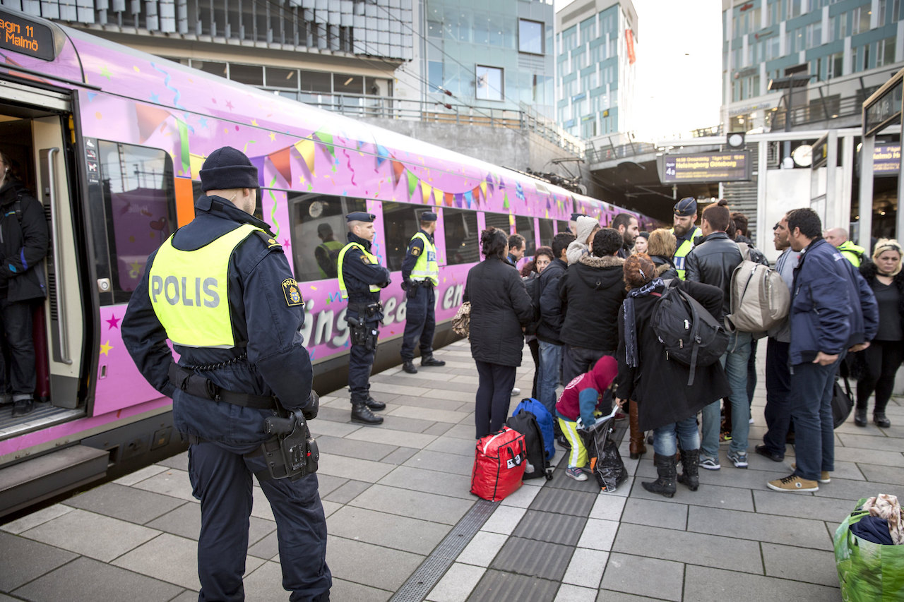 Swedish police and refugees at Hyllie station in Malmö.