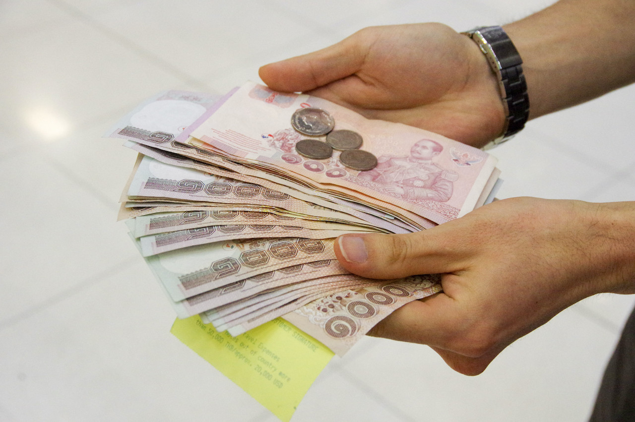 Thai baht coins and 1000 baht banknotes.