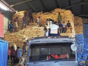 Bags of rice being unloaded at a Dili warehouse