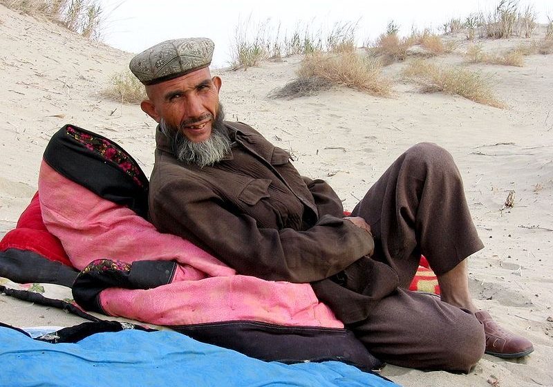 Uyghur camel guide in Taklamakan desert near Yarkand, autonomous region of Xinjiang, China