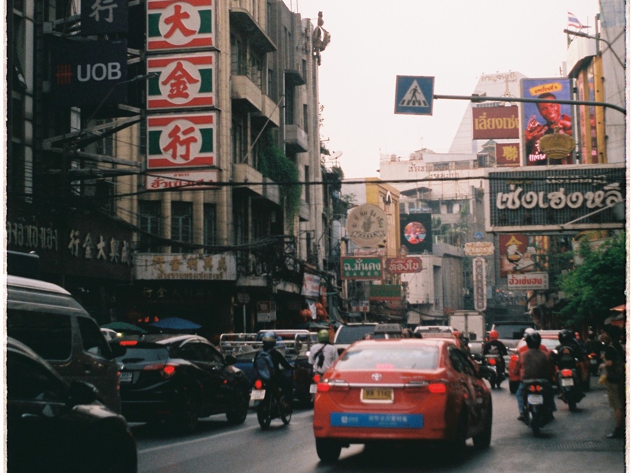 A taxi and motorcycles in Yaowarat Road, Bangkok.
