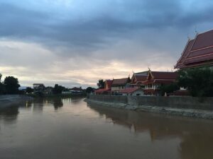 View of the Yom River and Wat Ratcha Thani from the Phra Ruang Bridge in Sukhothai.