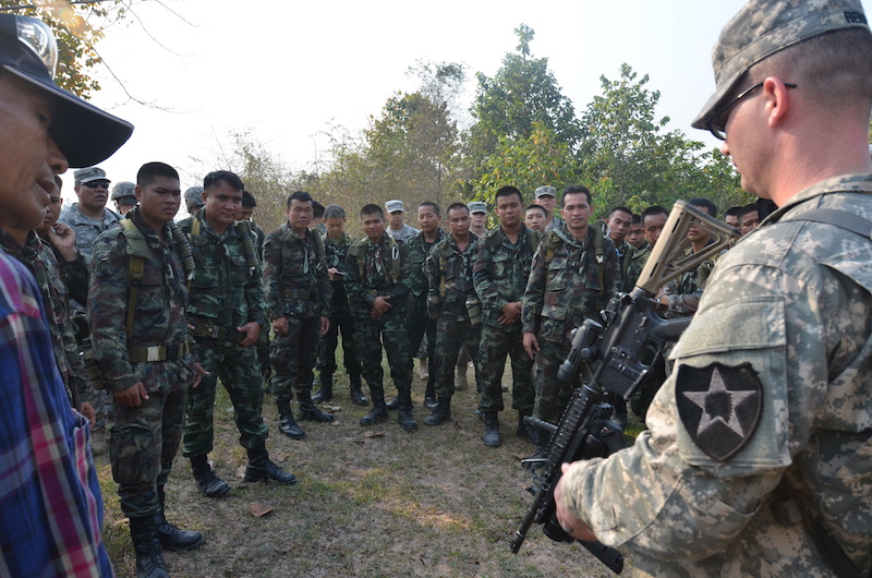 U.S. Army Staff Sgt. Andrew Renfroe, right, familiarizes Royal Thai Army counterparts with the M320 grenade launcher